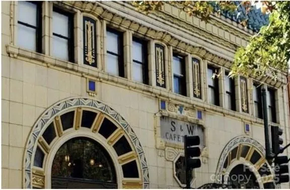 a view of a large building with many cars