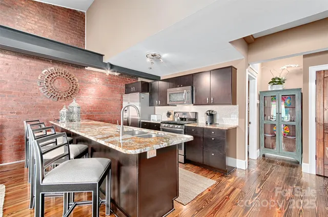 a kitchen with cabinets and wooden floor