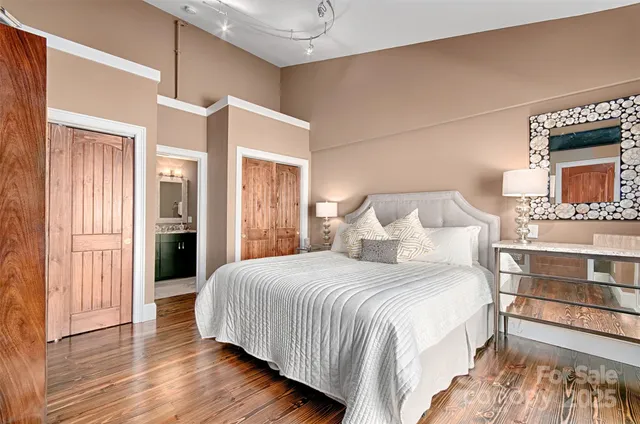 a bedroom with a bed and a chandelier