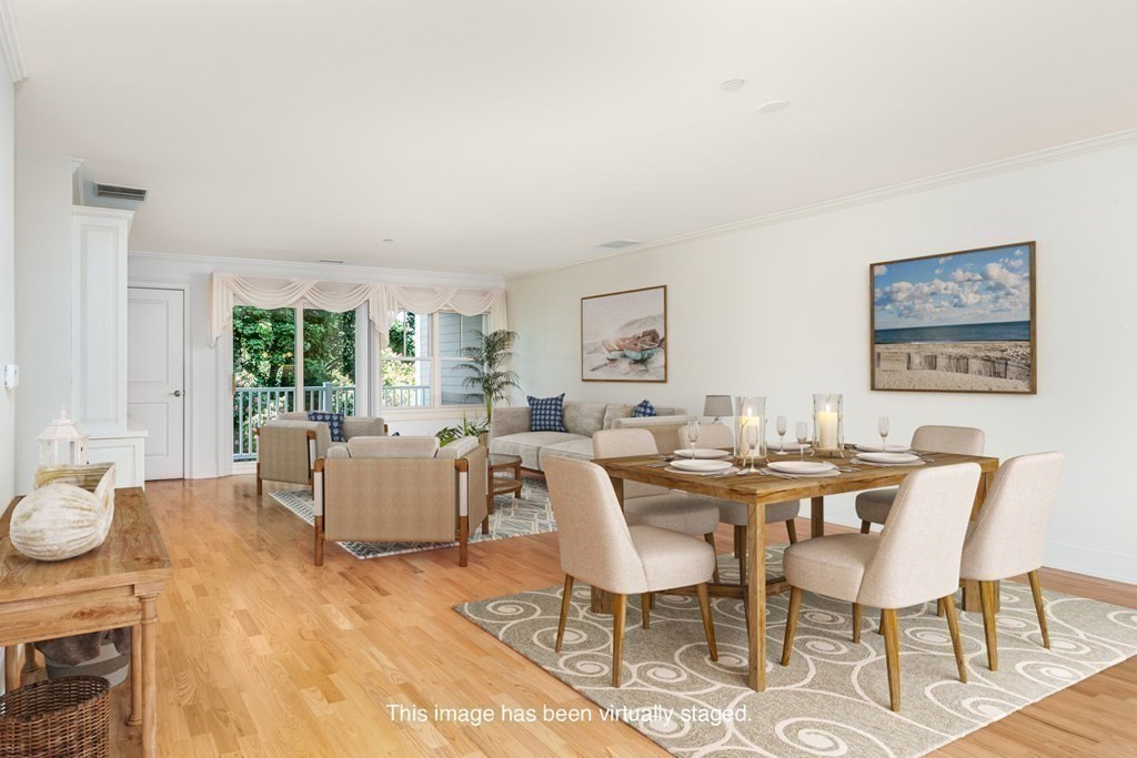 220 Humphrey Street, Unit 204 Marblehead, MA 01945 - Photo 11 of 29 a view of a dining room with furniture a rug and wooden floor