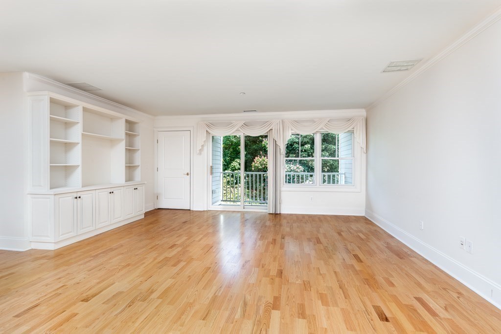 220 Humphrey Street, Unit 204 Marblehead, MA 01945 - Photo 13 of 29 wooden floor in an empty room with a window