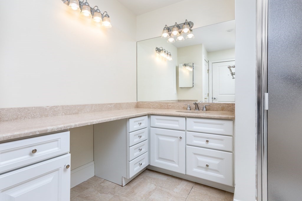 220 Humphrey Street, Unit 204 Marblehead, MA 01945 - Photo 17 of 29 a bathroom with a sink vanity and mirror
