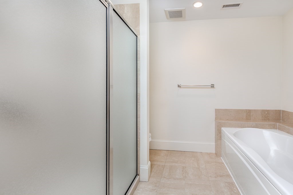 220 Humphrey Street, Unit 204 Marblehead, MA 01945 - Photo 18 of 29 a bathroom with a bathtub and shower