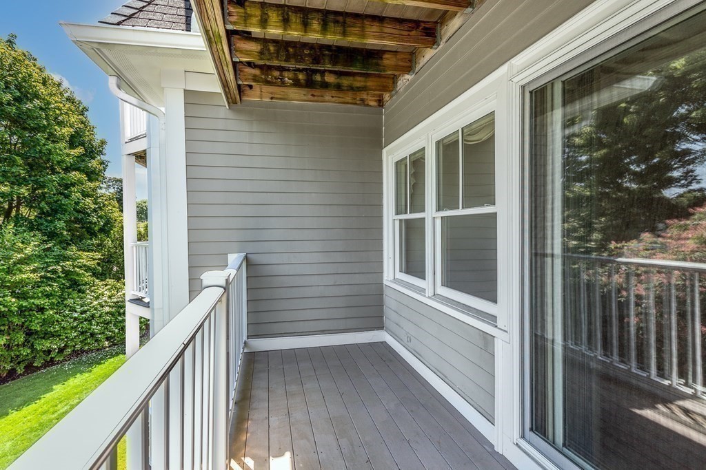 220 Humphrey Street, Unit 204 Marblehead, MA 01945 - Photo 23 of 29 a view of balcony with wooden floor and fence