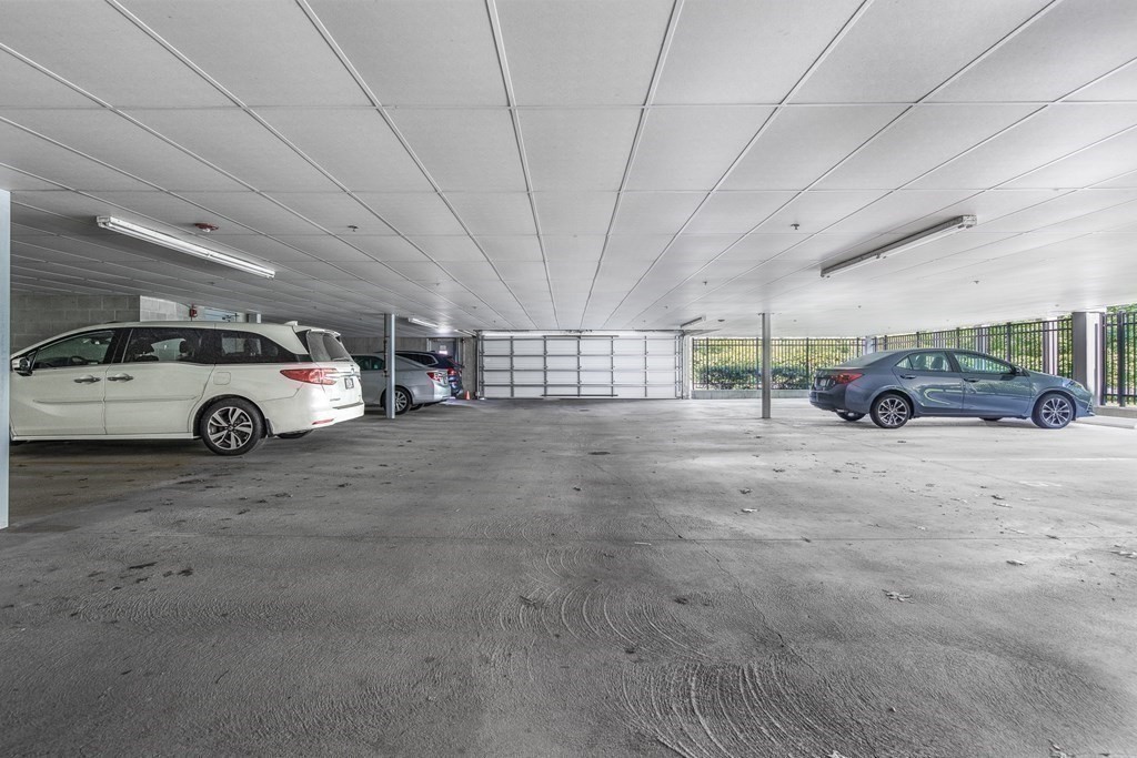 220 Humphrey Street, Unit 204 Marblehead, MA 01945 - Photo 25 of 29 a car parked in parking space in a parking