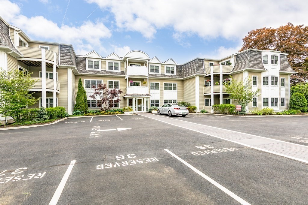220 Humphrey Street, Unit 204 Marblehead, MA 01945 - Photo 3 of 29 a buildings with car parked in front of it