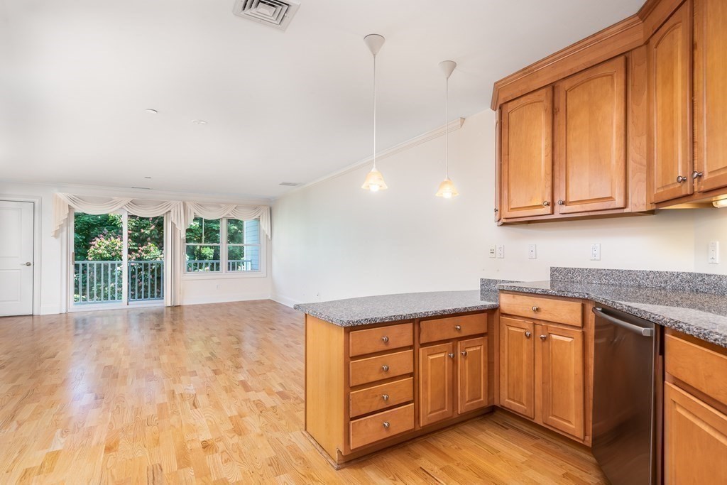 220 Humphrey Street, Unit 204 Marblehead, MA 01945 - Photo 10 of 29 a kitchen with wooden cabinets and a sink