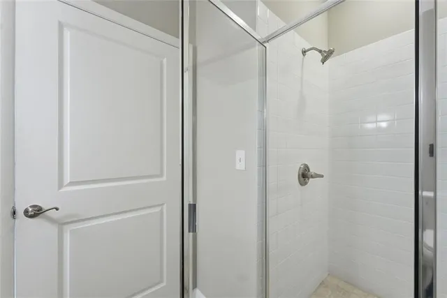a bathroom with a glass shower door