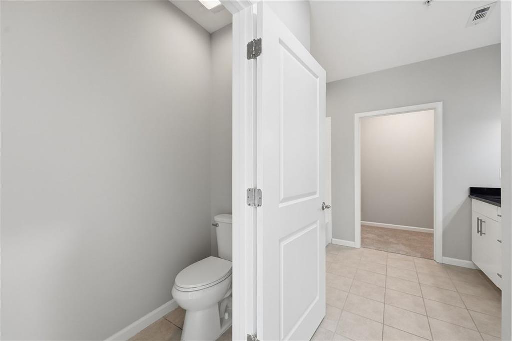 3400 Malone Drive, Unit 206 Atlanta, GA 30341 - Photo 18 of 31 a bathroom with a granite countertop toilet and a sink