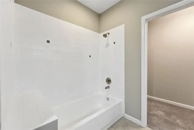 a bathroom with a bathtub and shower