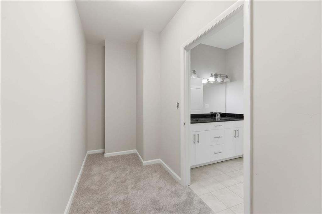 3400 Malone Drive, Unit 206 Atlanta, GA 30341 - Photo 21 of 31 a room with a light fixture a vanity and a mirror