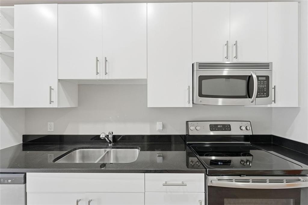 3400 Malone Drive, Unit 206 Atlanta, GA 30341 - Photo 4 of 31 a kitchen with white cabinets a sink and stainless steel appliances