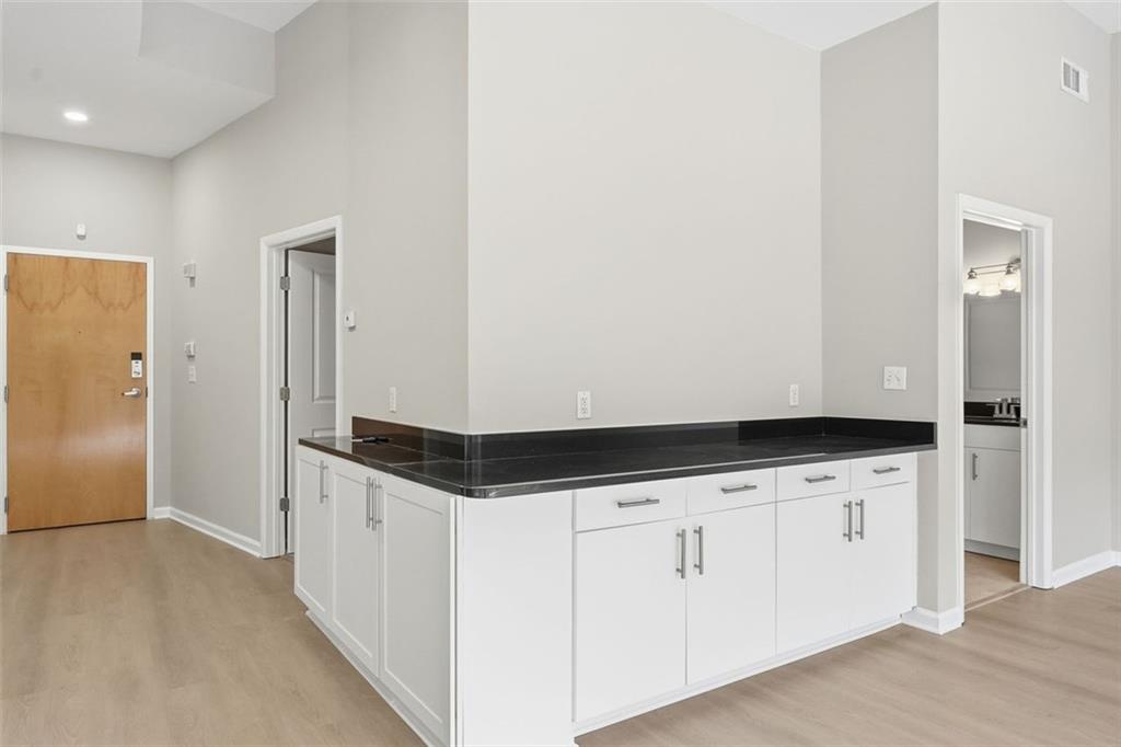3400 Malone Drive, Unit 206 Atlanta, GA 30341 - Photo 9 of 31 a kitchen with granite countertop white cabinets and white appliances