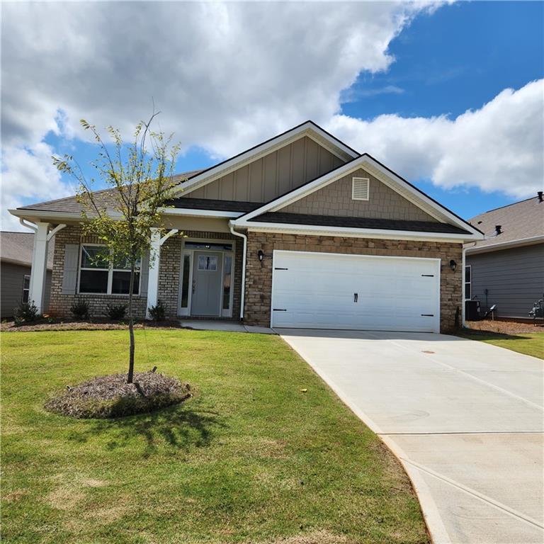 a front view of a house with a yard garage and outdoor seating