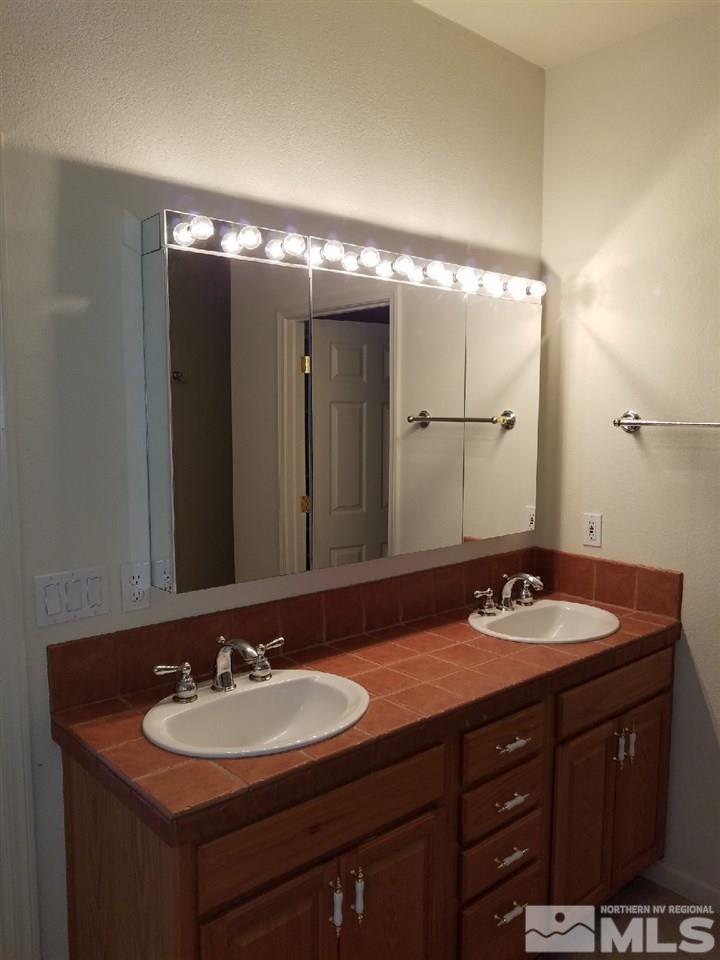 11000 Osage Road Reno, NV 89508 - Photo 12 of 20 a bathroom with a sink and a mirror