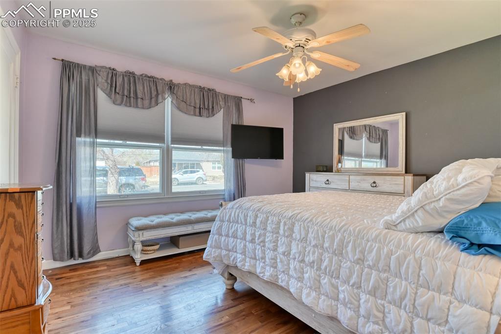 2409 Wahsatch Avenue Colorado Springs, CO 80907 - Photo 14 of 47 a bedroom with a bed and a large window with wooden floor