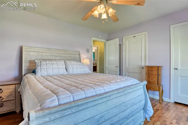 a bedroom with a large bed and a chandelier