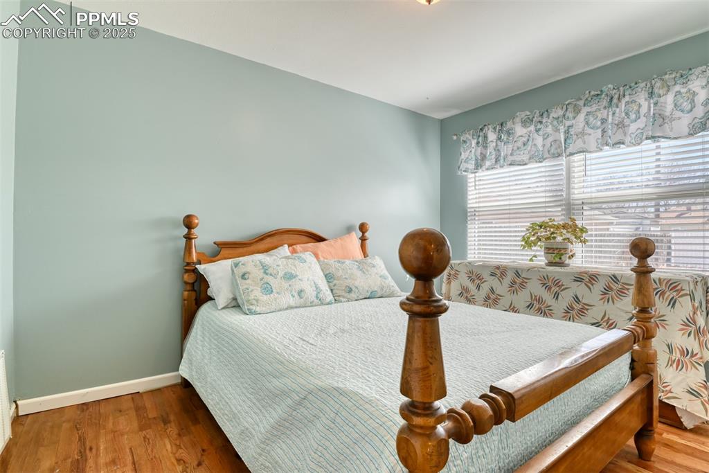 2409 Wahsatch Avenue Colorado Springs, CO 80907 - Photo 18 of 47 a bedroom with a bed and a chandelier