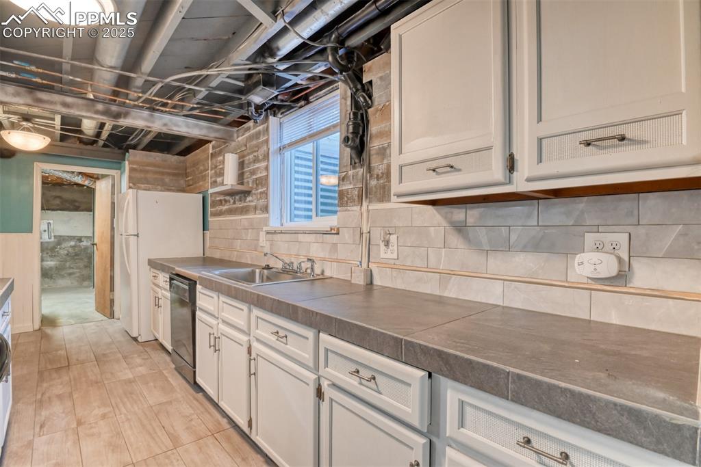 2409 Wahsatch Avenue Colorado Springs, CO 80907 - Photo 22 of 47 a kitchen with cabinets and a sink