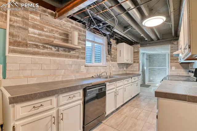 a kitchen with stainless steel appliances granite countertop a sink a stove and cabinets