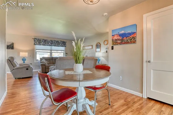 a view of a dining room with furniture and wooden floor