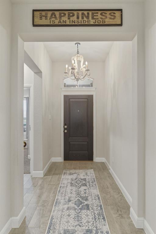 5621 Round Hl Road Denton, TX 76210 - Photo 3 of 27 a view of a hallway with a chandelier