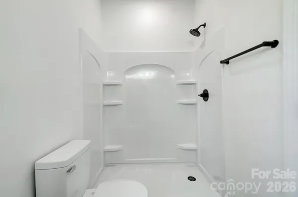 a bathroom with a toilet a sink and shower