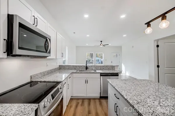 a kitchen with a sink stove and microwave