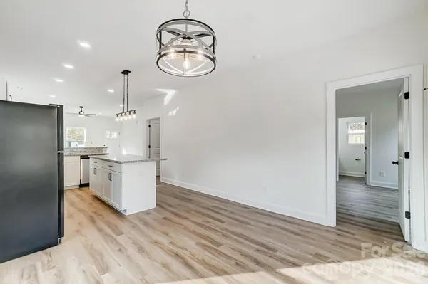 a view of kitchen with stainless steel appliances granite countertop cabinets and wooden floor