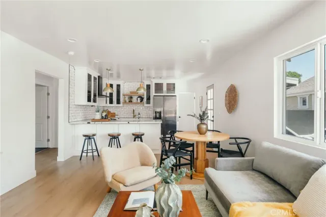 a living room with furniture and a kitchen area