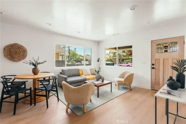 a kitchen with stainless steel appliances kitchen island granite countertop a stove a sink a dining table and chairs