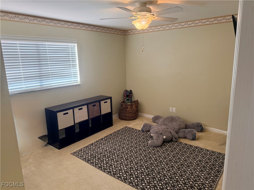 4577 Fairloop Run Lehigh Acres, FL 33973 - Photo 14 of 35 a bed room with a bed and a window