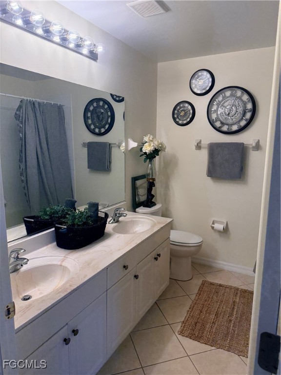 4577 Fairloop Run Lehigh Acres, FL 33973 - Photo 15 of 35 a bathroom with a sink and a mirror