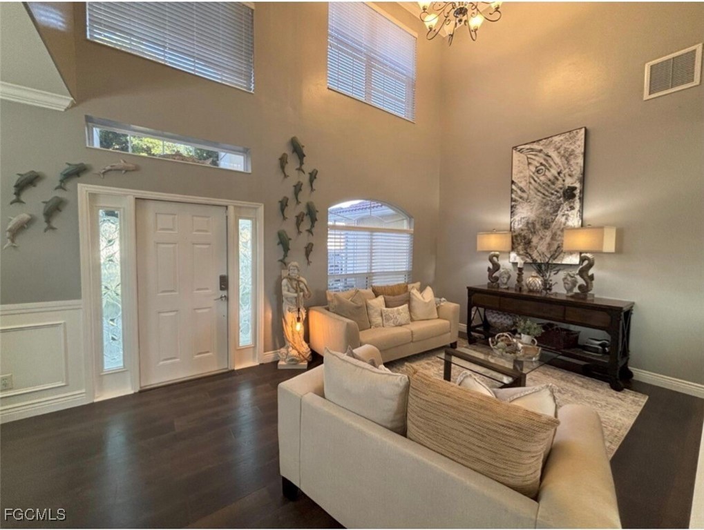 4577 Fairloop Run Lehigh Acres, FL 33973 - Photo 19 of 35 a living room with furniture and wooden floor