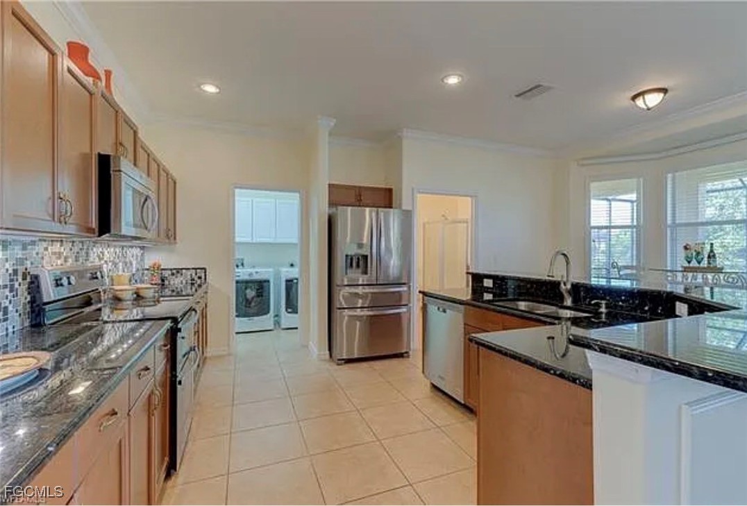 4577 Fairloop Run Lehigh Acres, FL 33973 - Photo 2 of 35 a kitchen with a sink a stove top oven and refrigerator