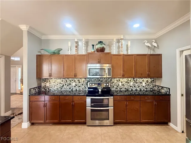 a kitchen with stainless steel appliances granite countertop a stove and cabinets