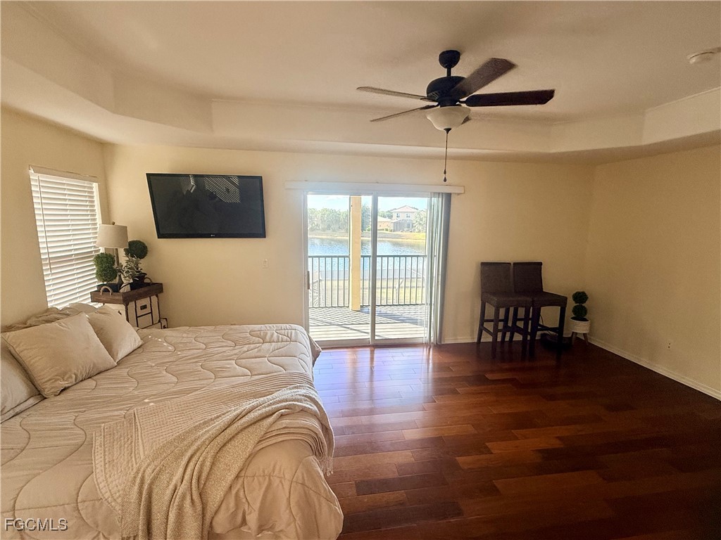 4577 Fairloop Run Lehigh Acres, FL 33973 - Photo 8 of 35 a bedroom with a bed and a chandelier