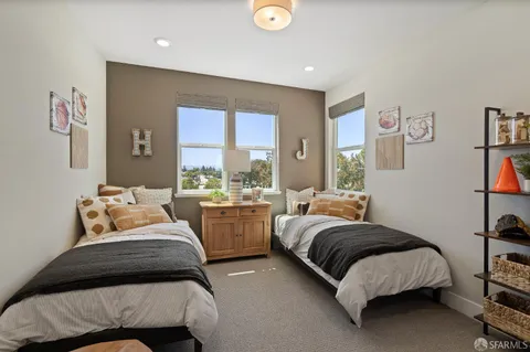 a bedroom with a bed and a large window