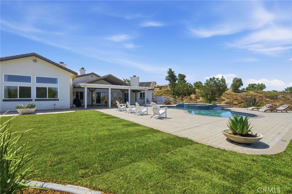 41110 Los Ranchos Circle Temecula, CA 92592 - Photo 60 of 77 a view of a house with a yard potted plants and a table