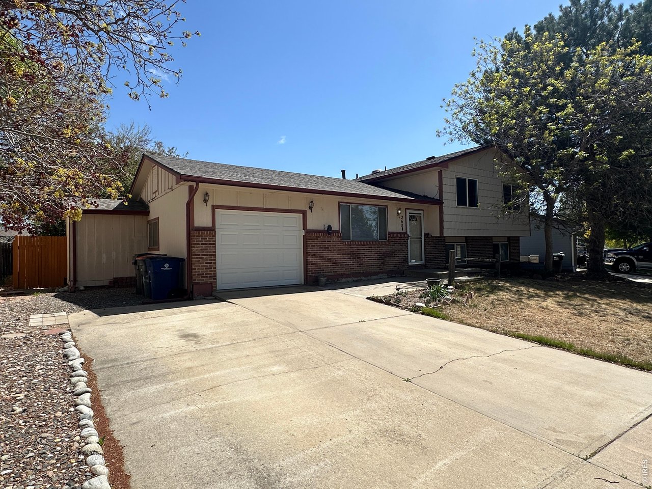 268 Fifth Street Firestone, CO 80520 - Photo 2 of 25 a front view of a house with a yard and garage
