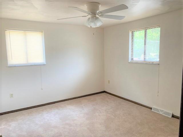 1141 12th Street McKees Rocks, PA 15136 - Photo 11 of 25 an empty room with a window and a fan