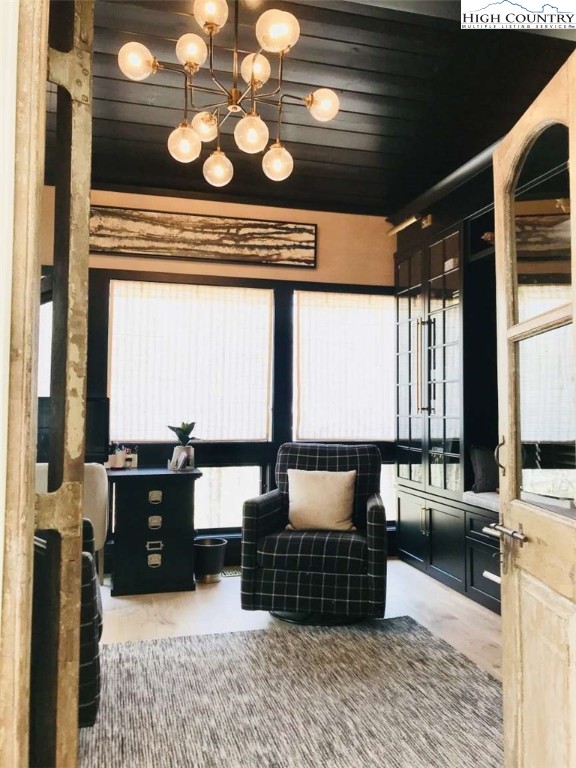 509 Crystal Mountain Road Boone, NC 28607 - Photo 13 of 24 a living room with couches a large dining table and chairs with wooden floor