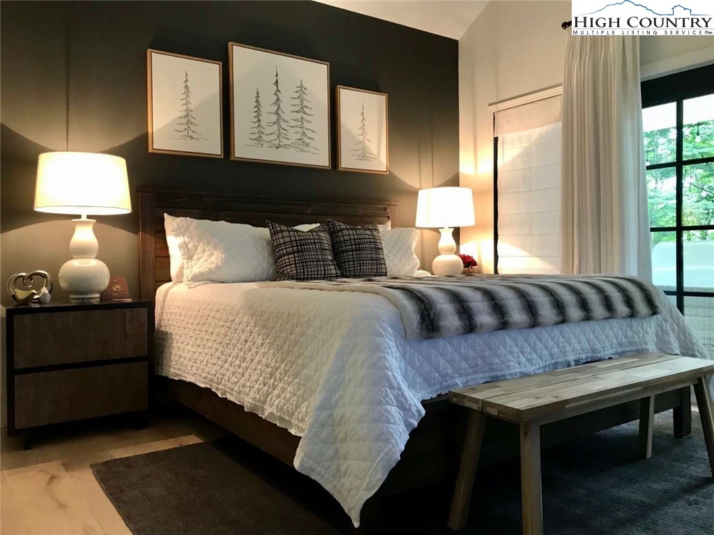 509 Crystal Mountain Road Boone, NC 28607 - Photo 15 of 24 a bedroom with a bed and a lamp on dresser