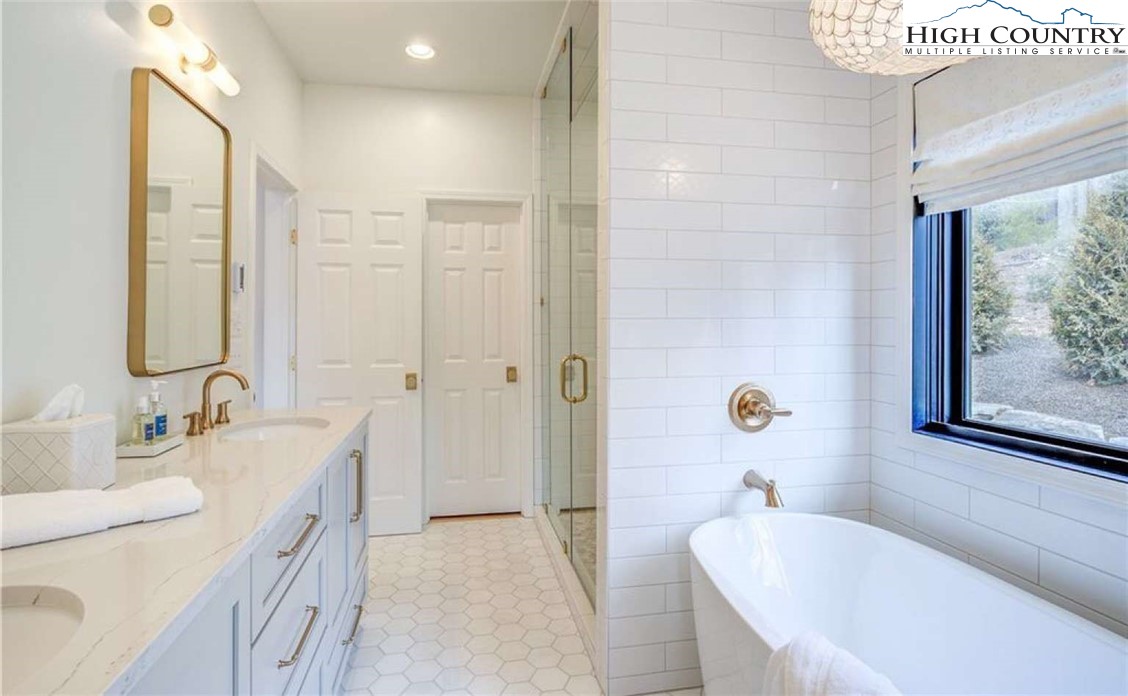 509 Crystal Mountain Road Boone, NC 28607 - Photo 18 of 24 a bathroom with a tub sink and mirror