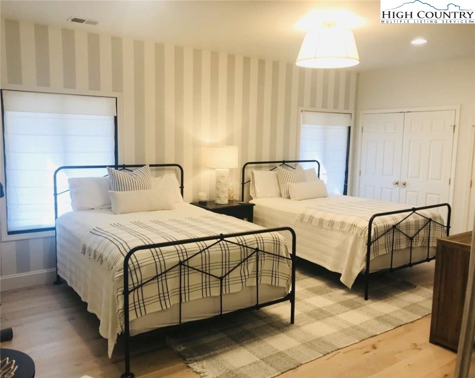 509 Crystal Mountain Road Boone, NC 28607 - Photo 19 of 24 a bedroom with bed and a chandelier