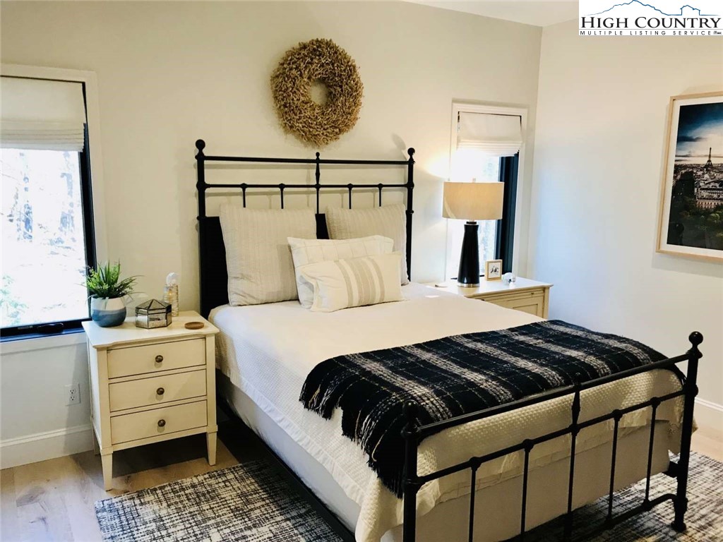 509 Crystal Mountain Road Boone, NC 28607 - Photo 21 of 24 a bedroom with a bed and painting on the wall