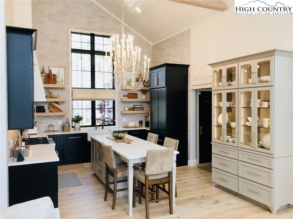 509 Crystal Mountain Road Boone, NC 28607 - Photo 7 of 24 a kitchen with stainless steel appliances kitchen island granite countertop a refrigerator a stove a sink dishwasher with a dining table and chairs