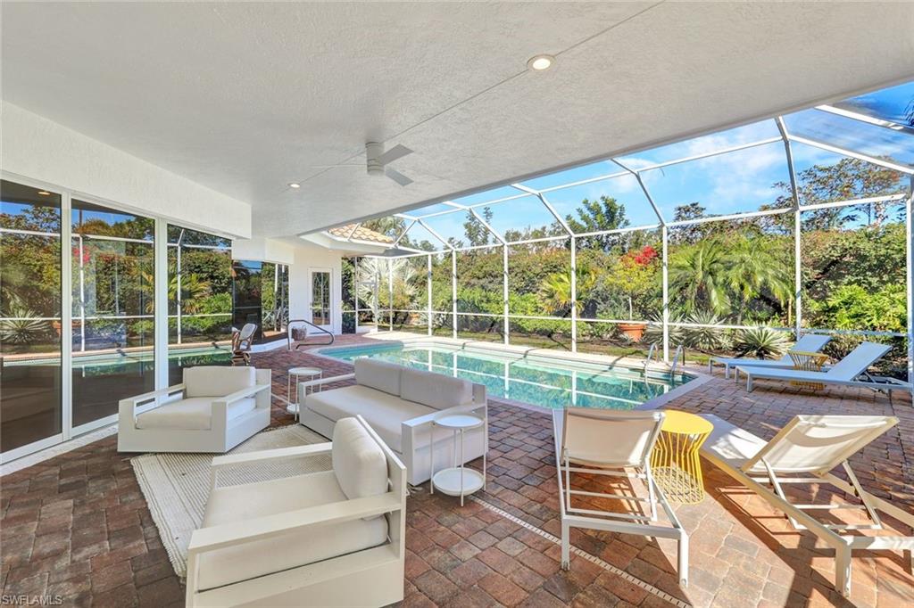 874 Wyndemere Way Naples, FL 34105 - Photo 26 of 32 a living room with furniture and a large window