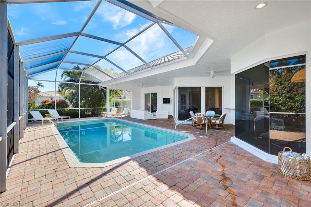874 Wyndemere Way Naples, FL 34105 - Photo 30 of 32 a view of a patio with swimming pool table and chairs