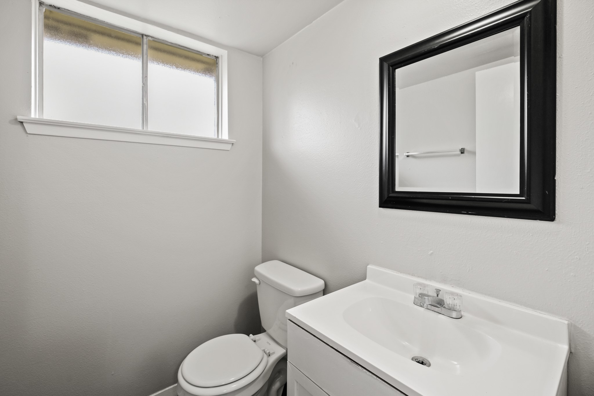 122 West Havner Lane Houston, TX 77037 - Photo 7 of 11 a bathroom with a toilet sink and mirror